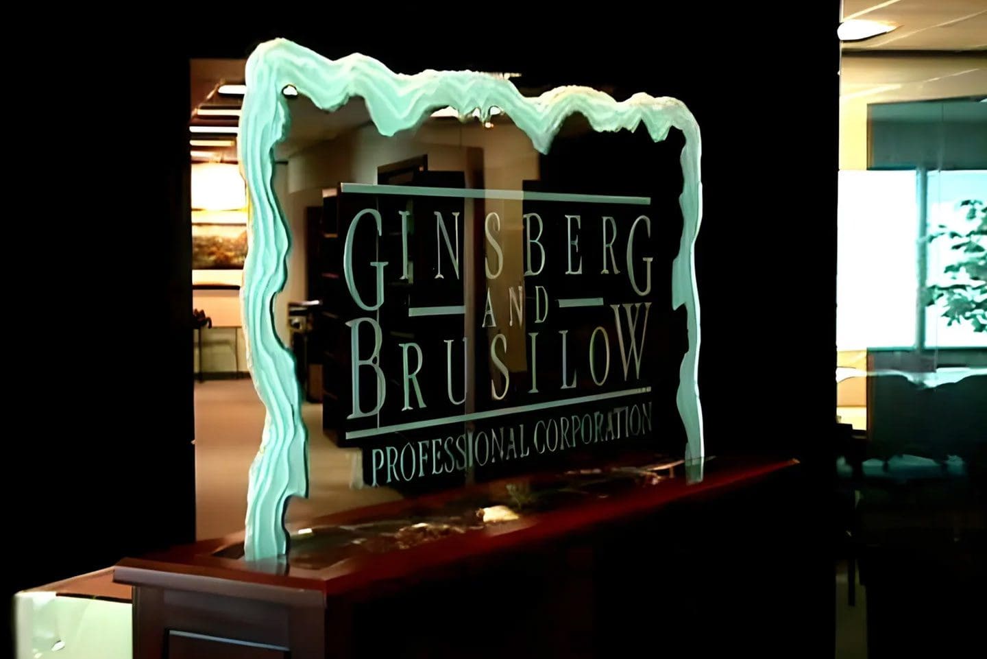 A glass sign with the words ginsberg and bruslow on it.