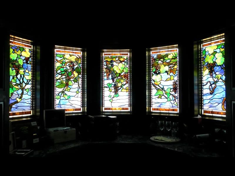 A room with several windows that have been stained glass.