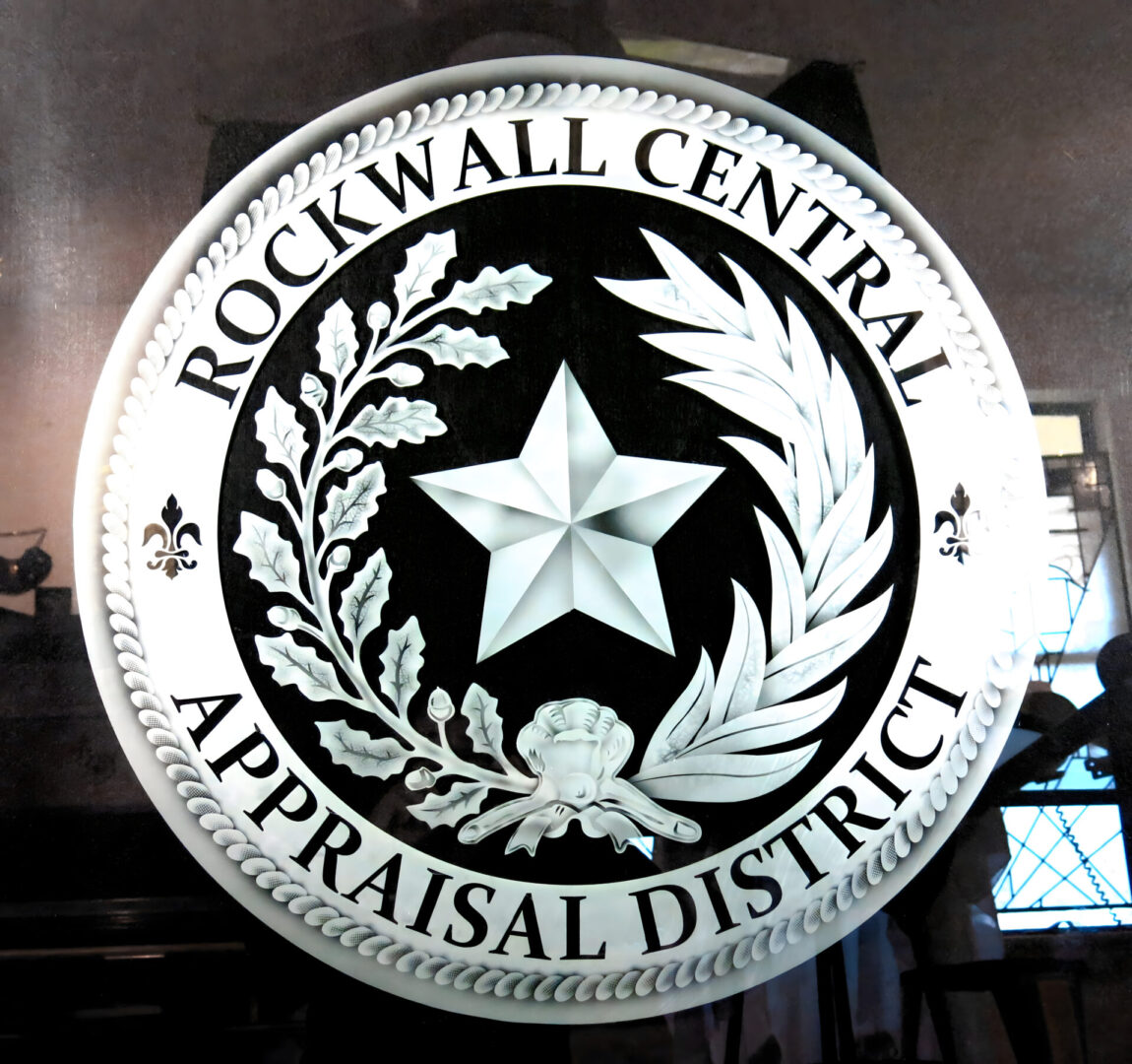 Seal of the rockwall central appraisal district displayed on a circular plaque with a star and decorative motifs.