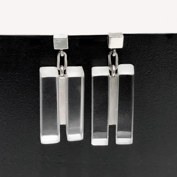 Silver rectangular bar earrings displayed against a black background.