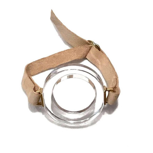 Transparent circular object with a cardboard band.