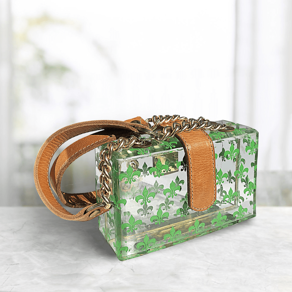 A green purse with leaves on it
