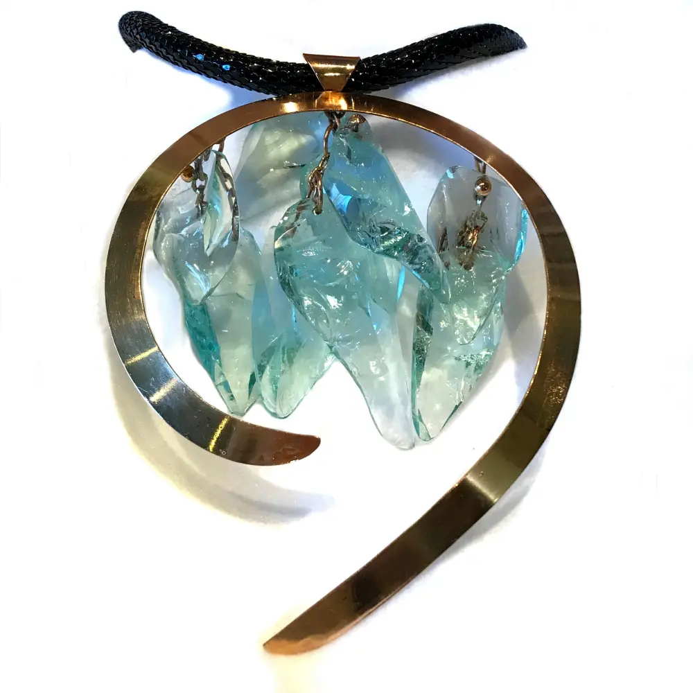 A pendant with a circular metal frame and three turquoise glass fish hanging on a black cord.